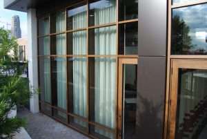 closeup of large industrial black & brown building with large curtain wall with steel glass windows