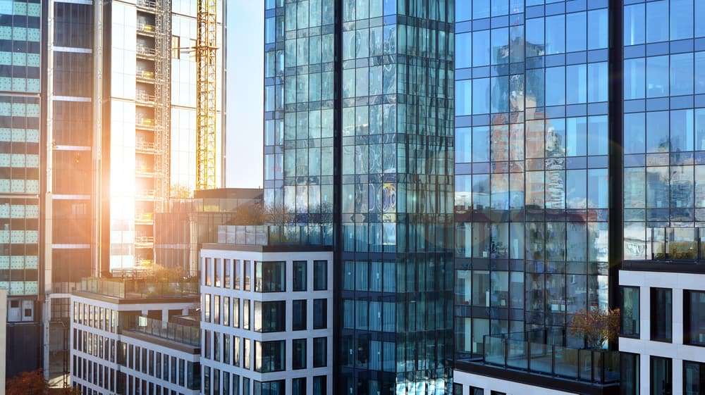 An image of a commercial building curtain wall which also has commercial storefront windows and doors